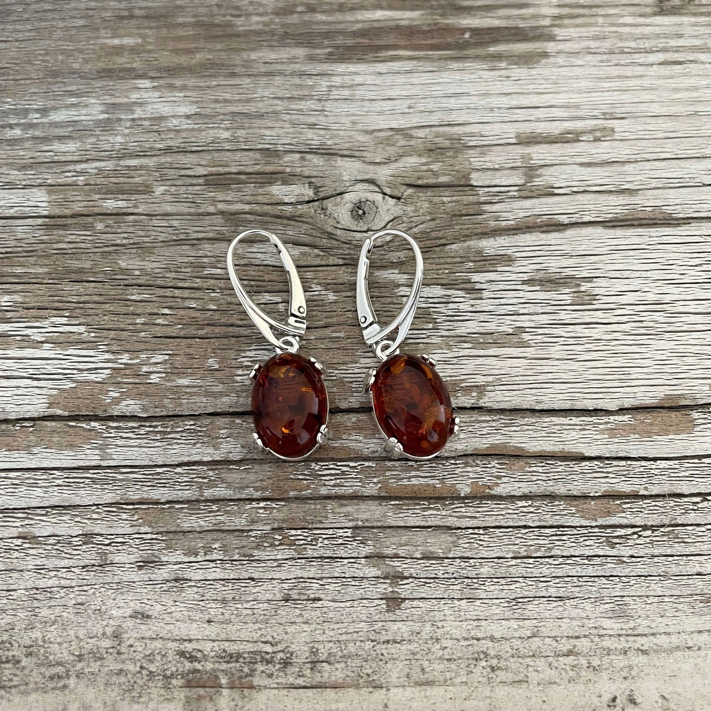 lever back amber oval shaped cognac coloured drop earrings set in sterling silver