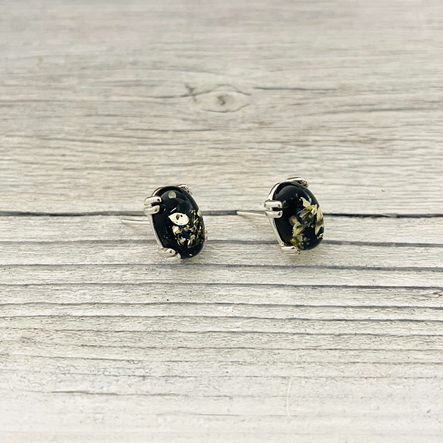 oval shaped green amber stud earrings left side