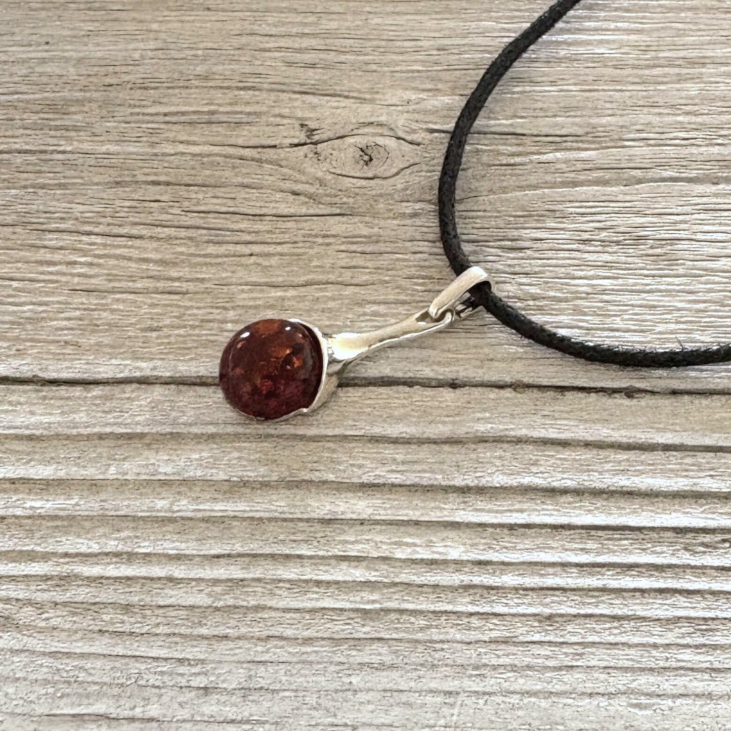 Cognac Baltic amber pendant set in polished sterling silver.