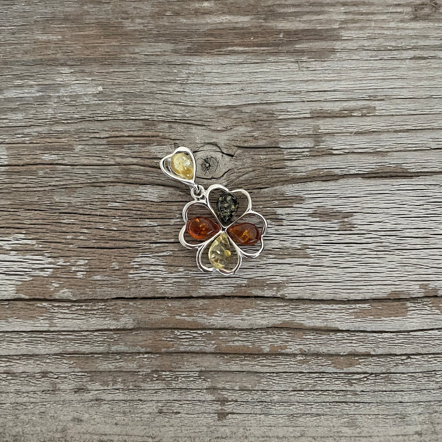 green yellow and cognac amber flower shaped pendant set in sterling silver