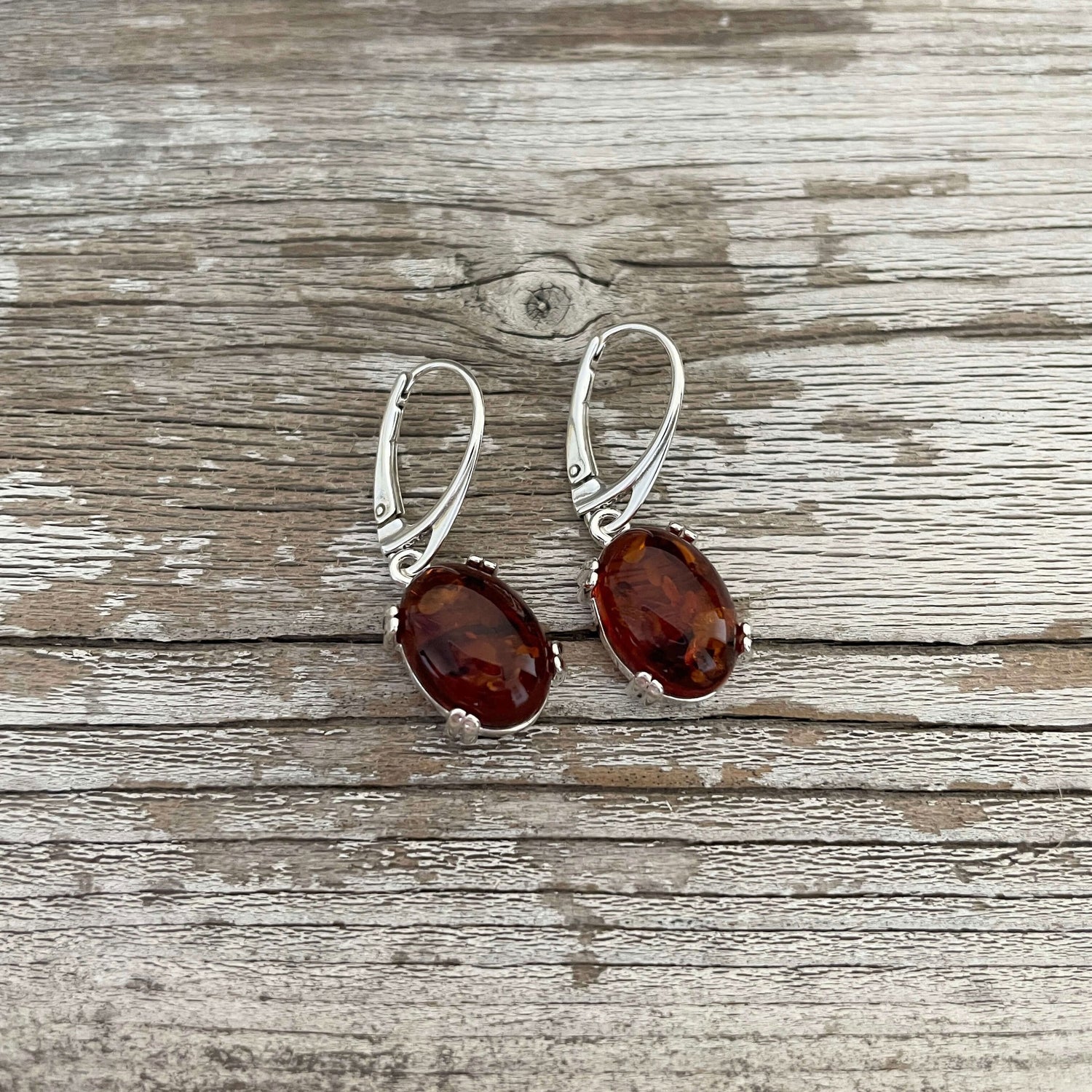 polished amber oval shaped cognac coloured drop earrings set in sterling silver