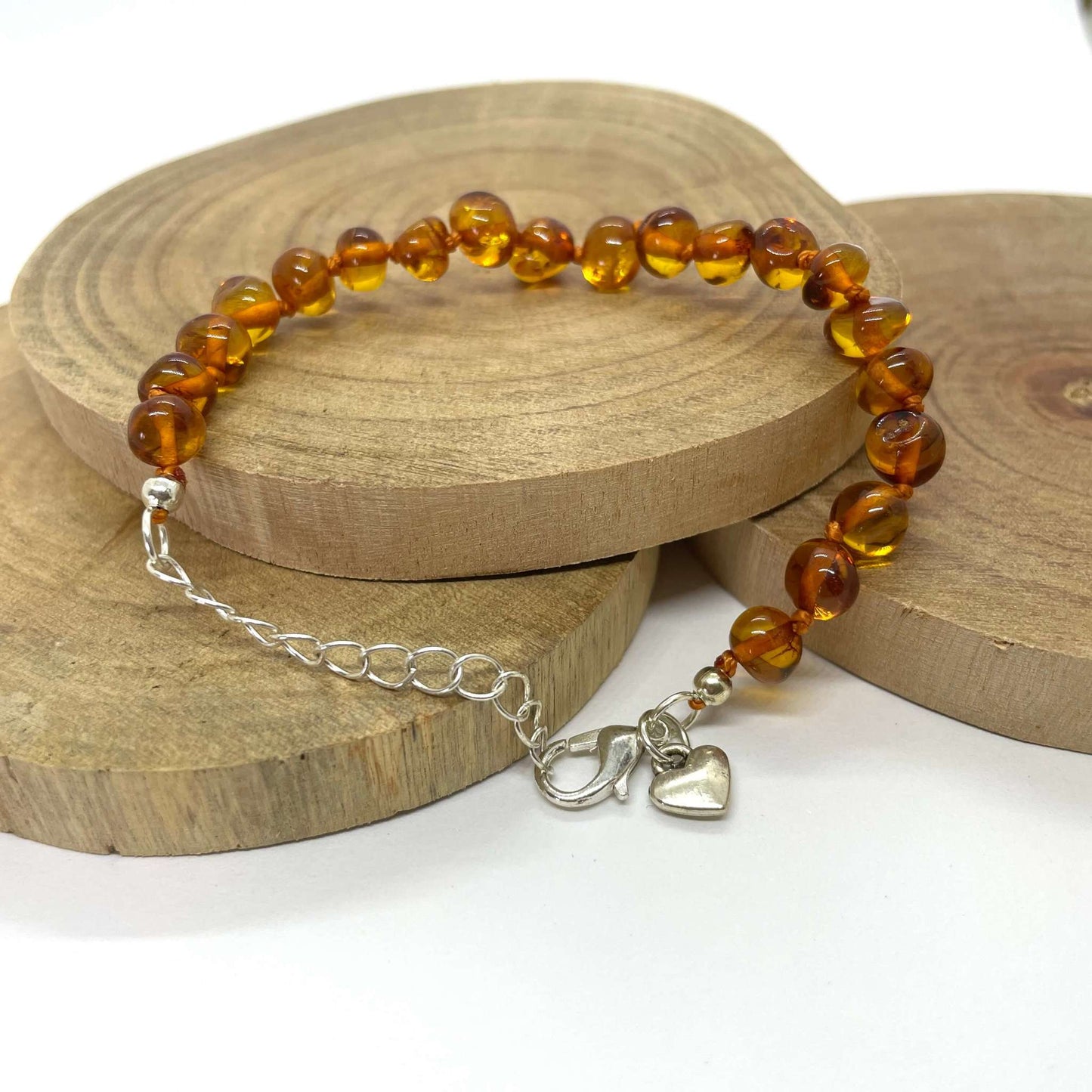 cognac coloured amber beaded bracelet with silver heart