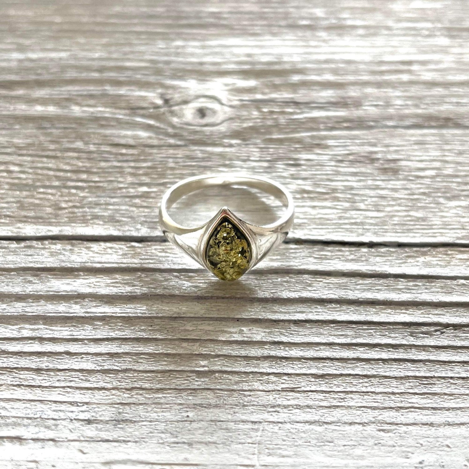 green amber tear drop shaped ring set in sterling silver