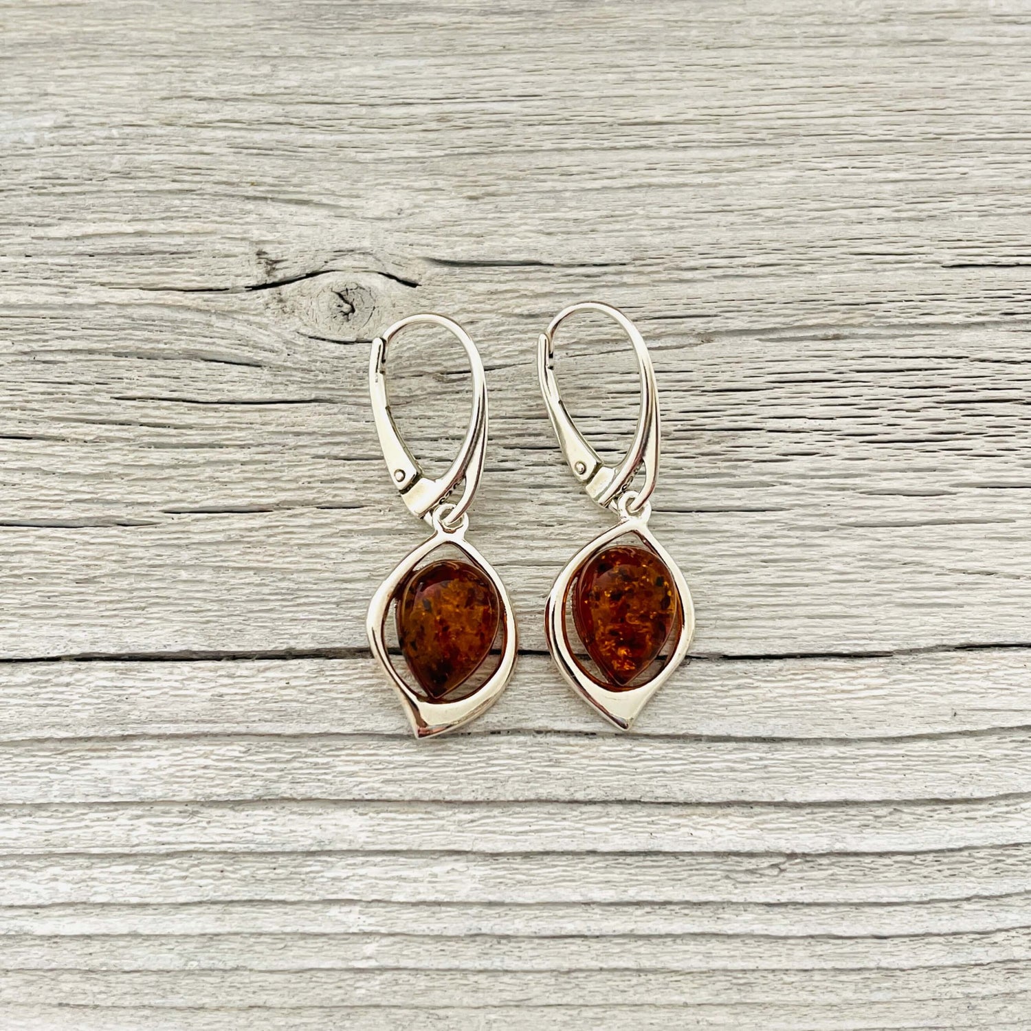 silver oval shaped amber earrings set in sterling silver