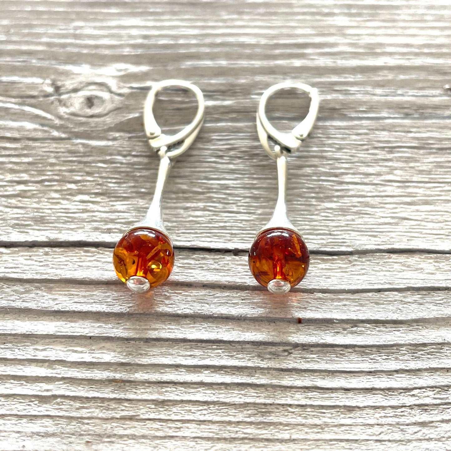 sterling silver dangle earrings with ball shaped amber