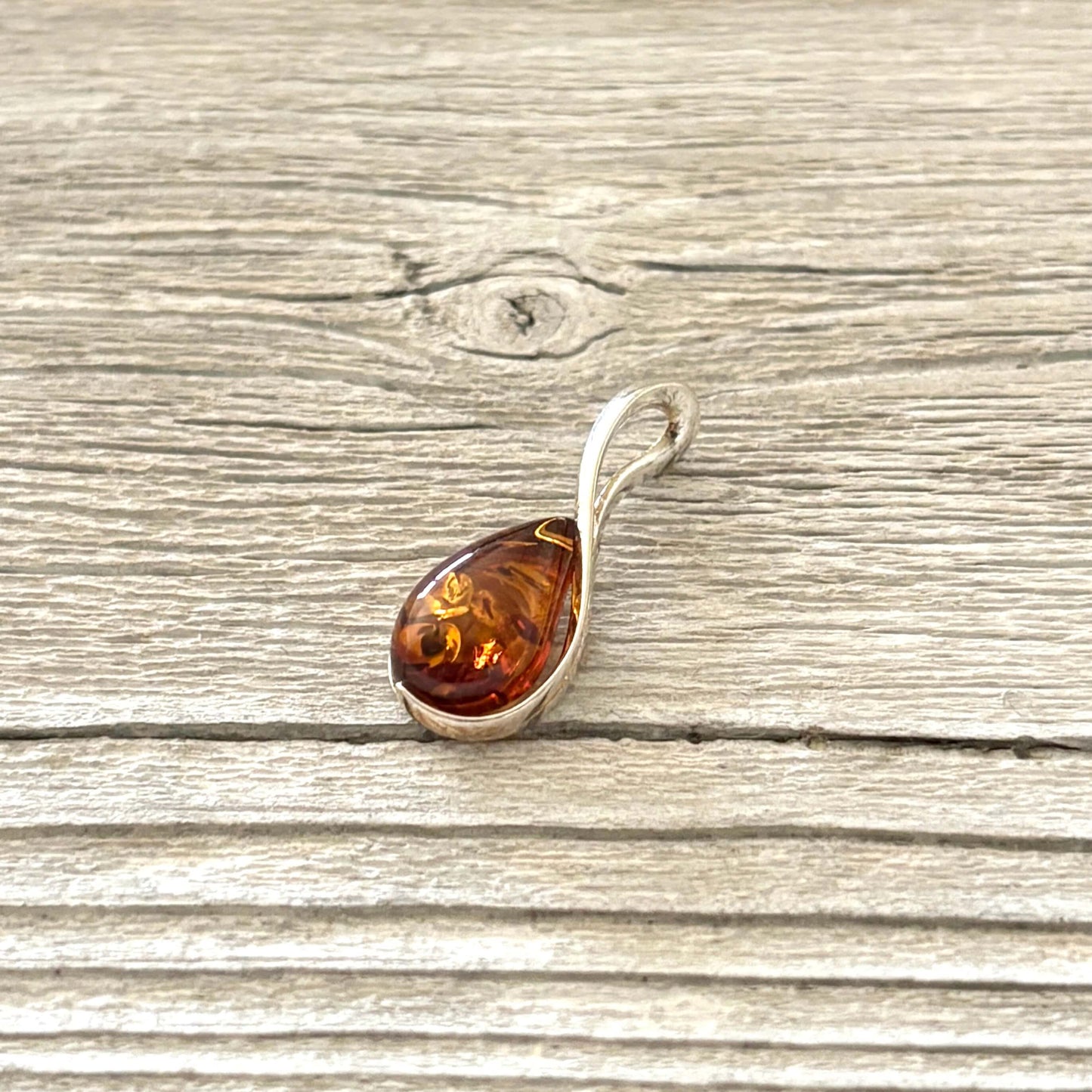 Teardrop shaped amber pendant set in sterling silver 