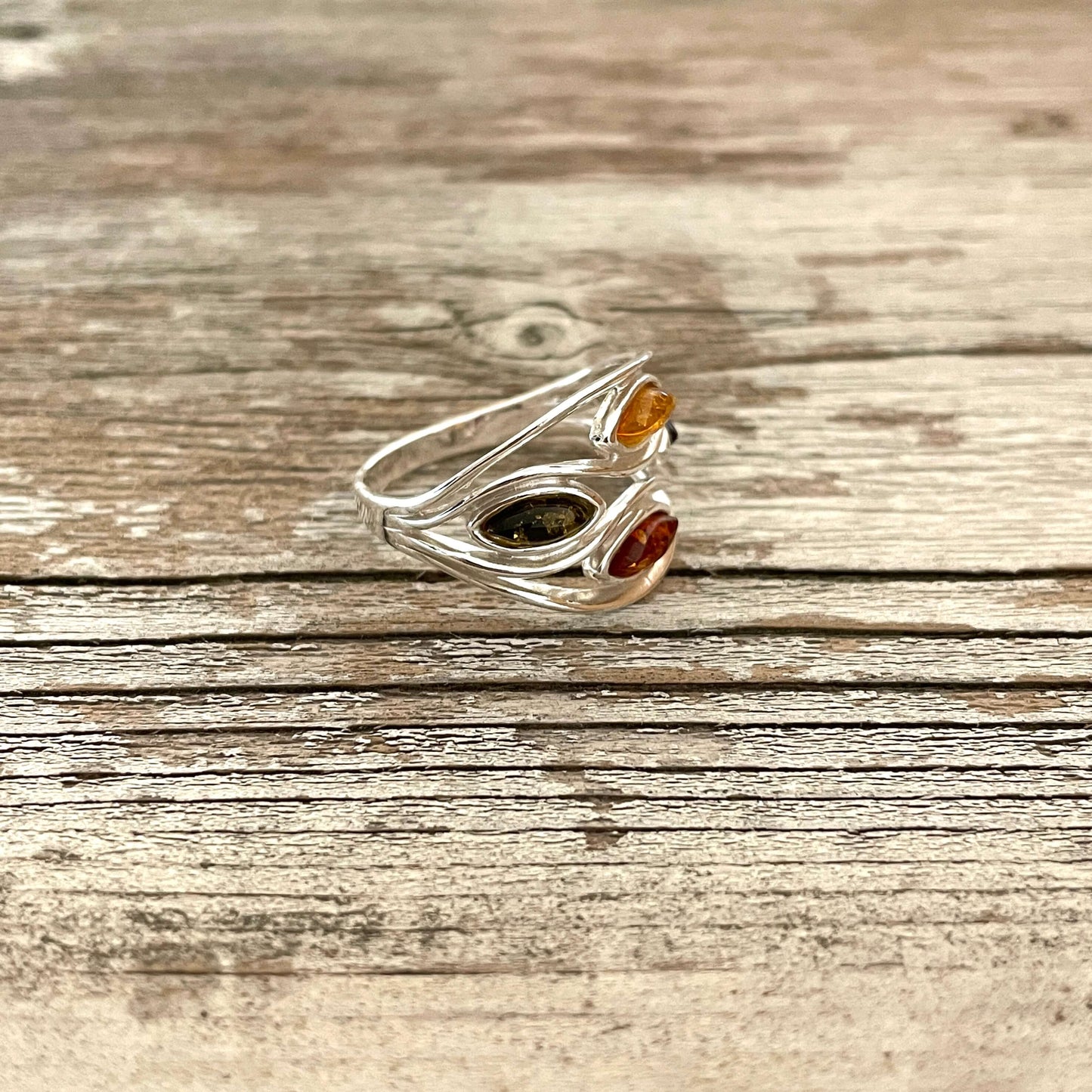 mixed coloured oval shaped green honey cognac and cherry amber sterling silver ring