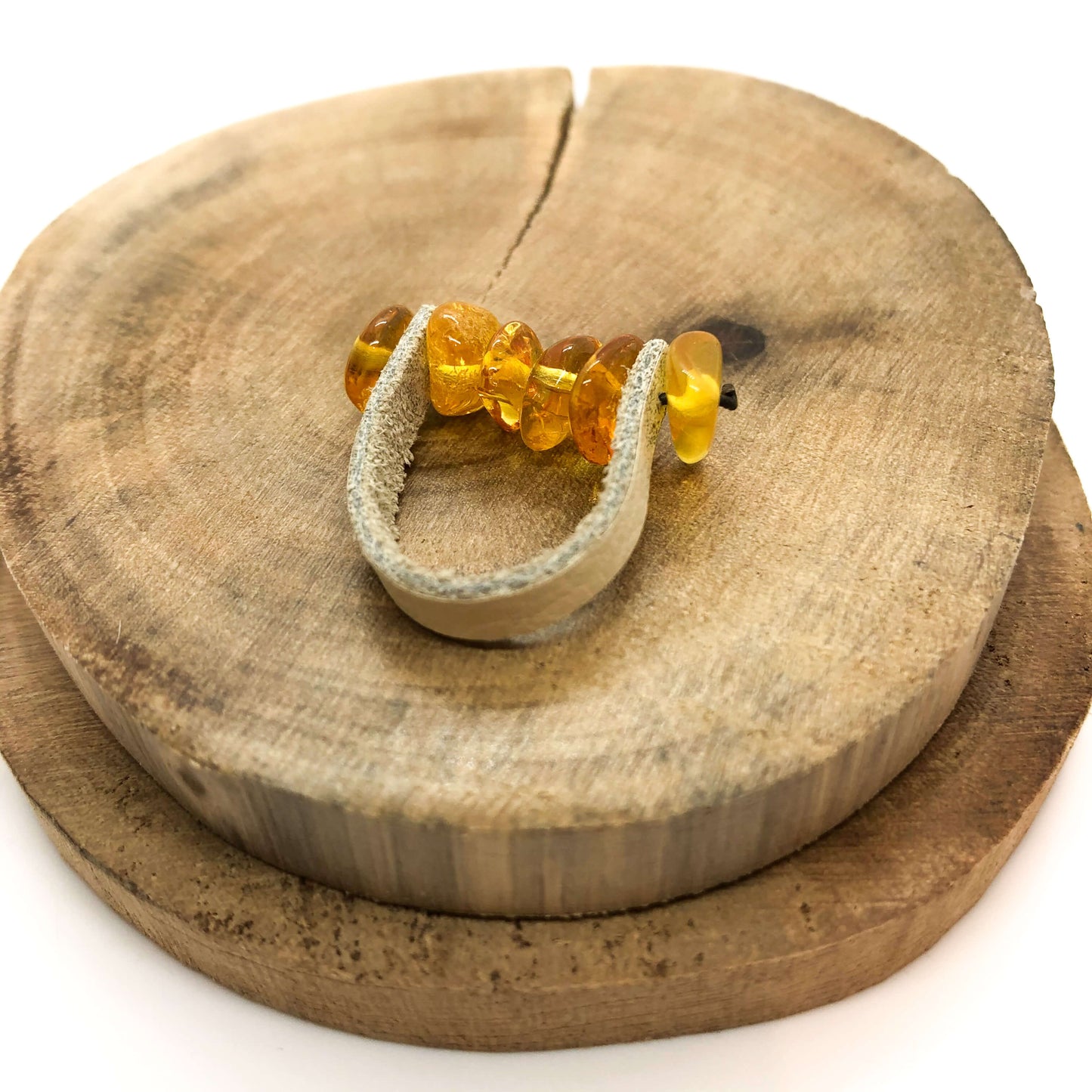 natural Baltic cognac amber with tan leather ring