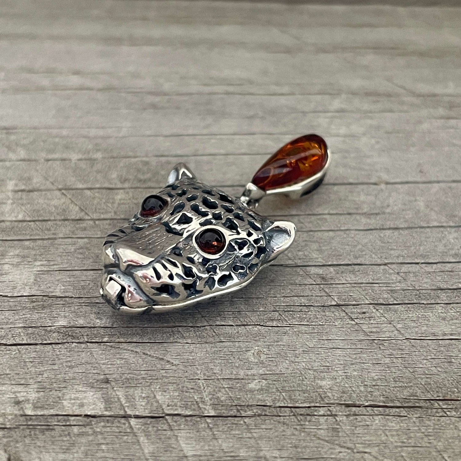 Sterling silver shaped tiger pendant with amber link and amber eyes