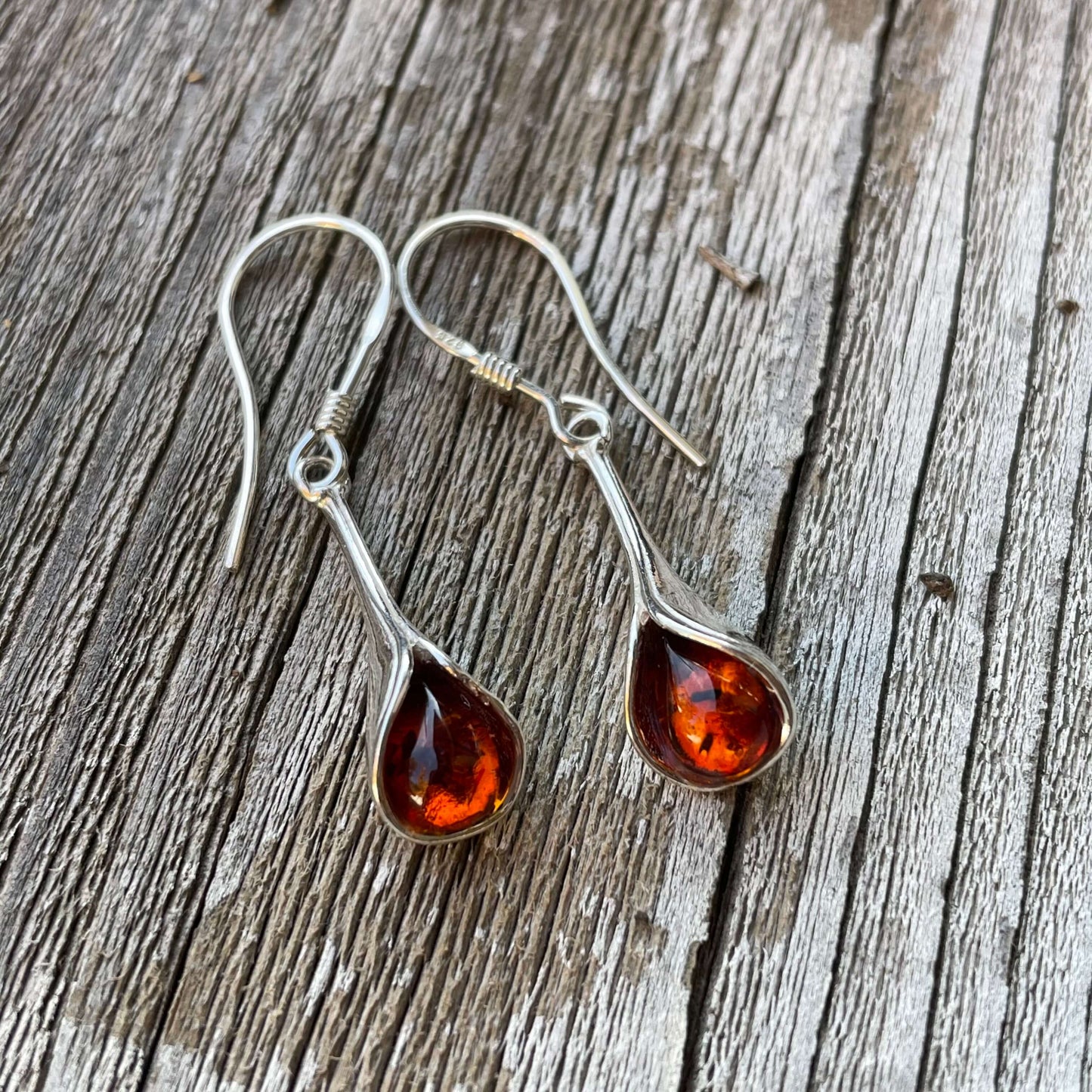trumpet shaped sterling silver and cognac amber hook earrings