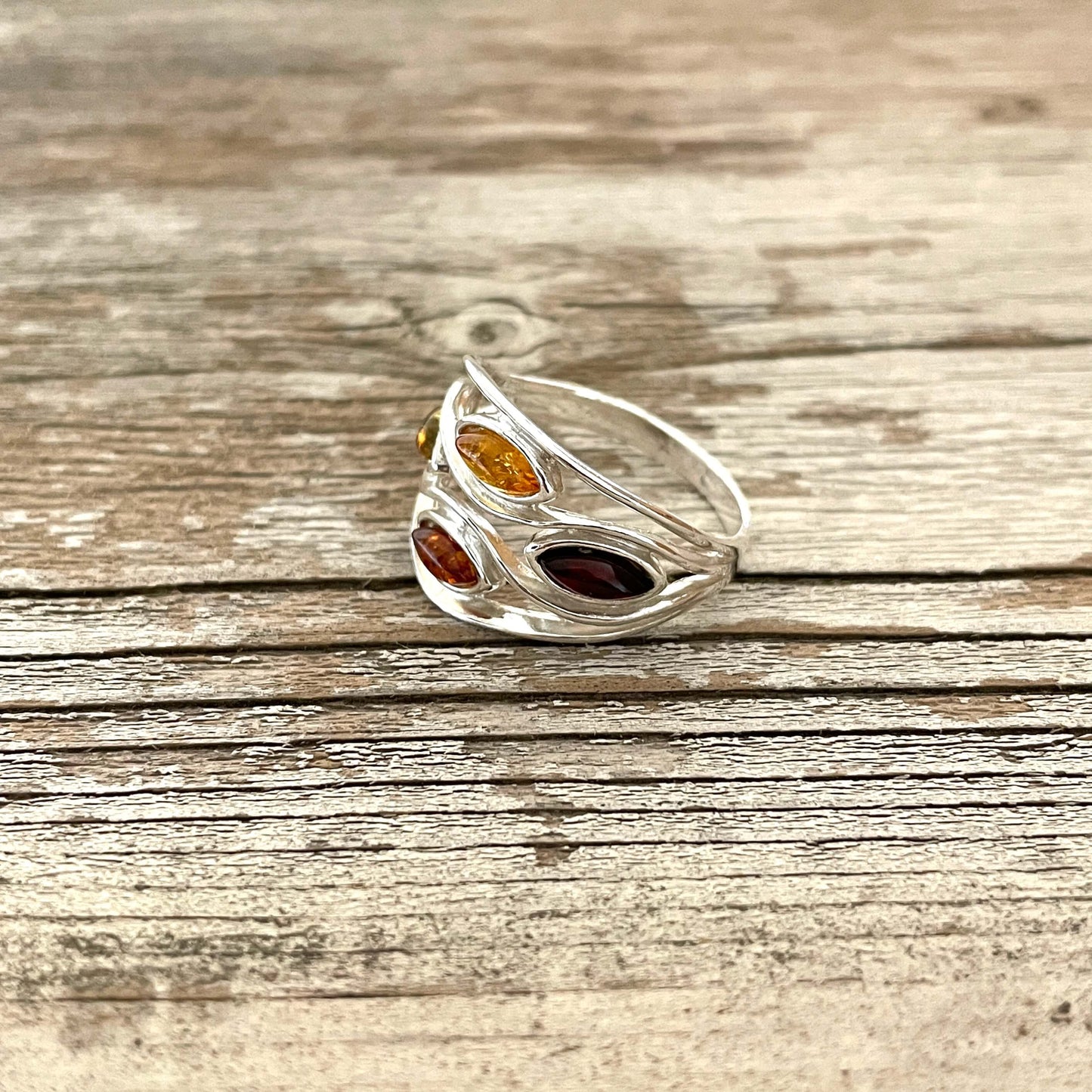 mixed coloured oval shaped green honey cognac and cherry amber sterling silver ring
