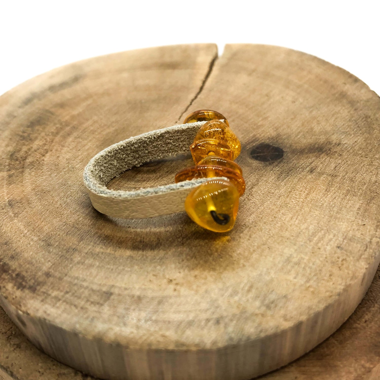 natural Baltic cognac amber with tan leather ring