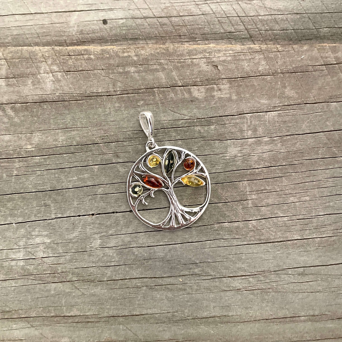 round sterling silver tree of life amber pendant with green, cognac and yellow amber